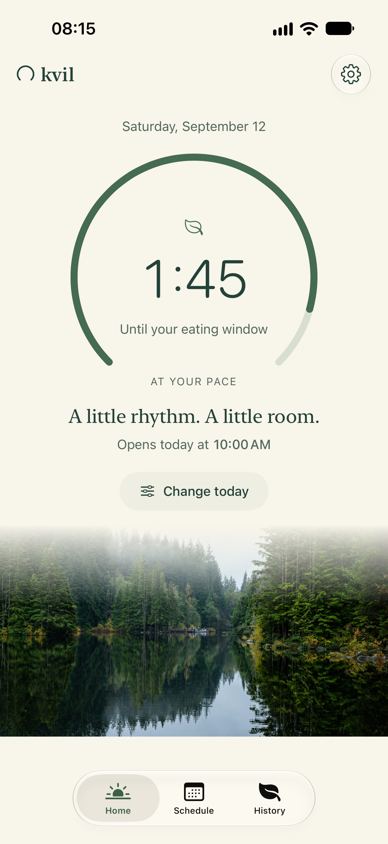 Kvil Home, with a large open-circle timer showing one hour and forty-five minutes until an eating window opens at 10, above a photograph of a calm lake and green forest.